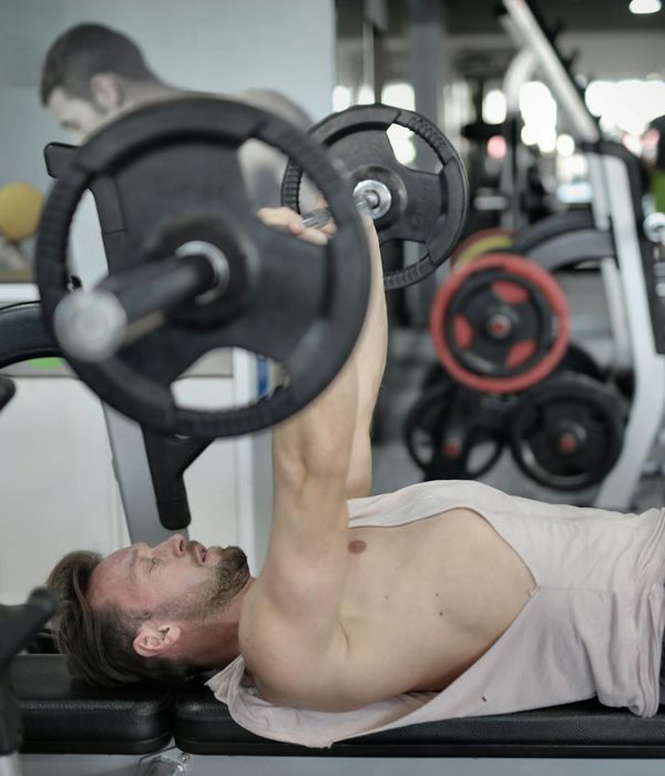 Strong man standing in a focused posture in gym